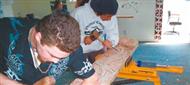 Young Maori doing carving