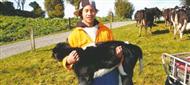 Young farmer holding animal