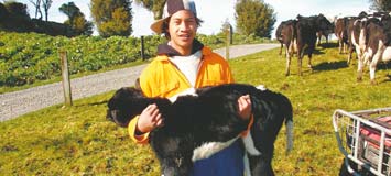 Young farmer holding animal