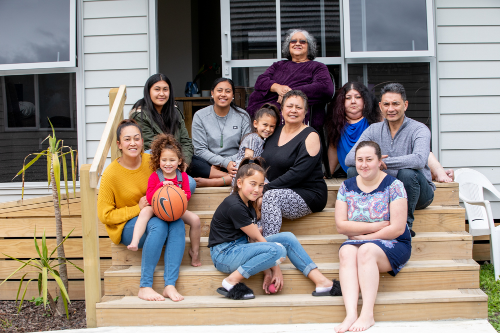 The Tawhai whānau in front of their new whare. Photo credit: Josie McClutchie.