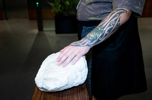 Hand resting on a stone